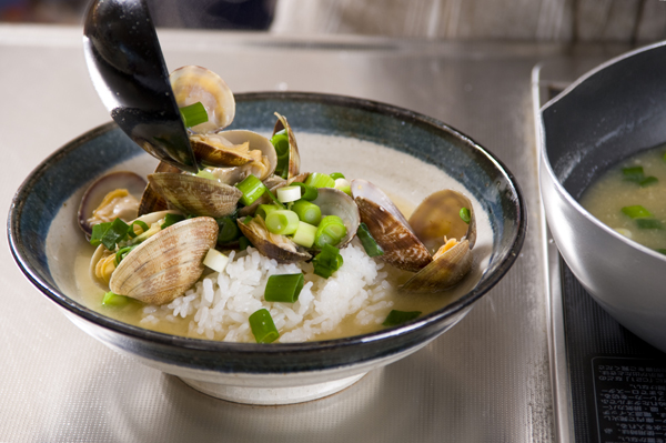 青ネギを加えてひと煮立ちさせたら、丼に盛ったごはんにかける。