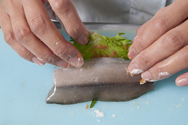 たたいた梅を塗った青じそで、水魚を巻き、天ぷら粉の粉だけをまずまぶす。残った天ぷら粉を水でとき作った衣をつける。